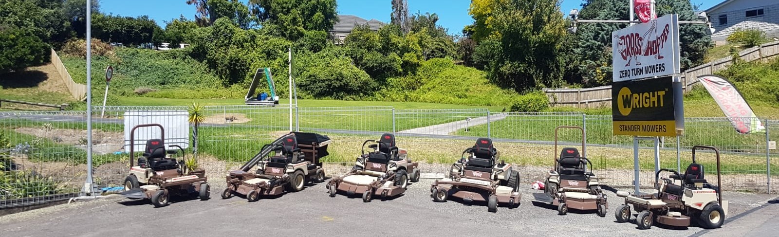 Grasshopper and Wright zero turn mowers lined up at the ZTR Mowers yard